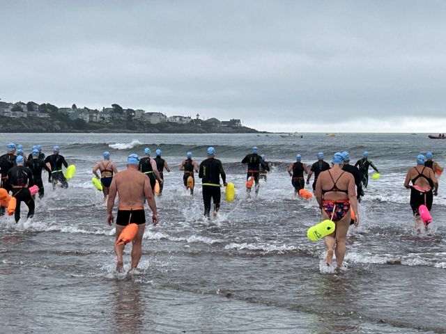 Swimmers head into the ocean